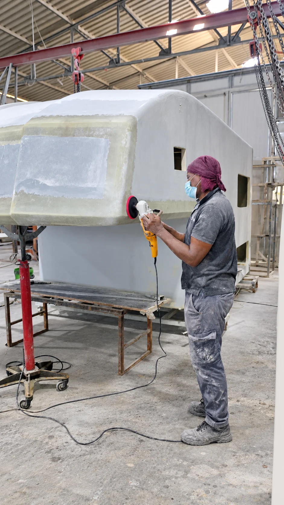 Surface finishing on an unfinished camper shell.